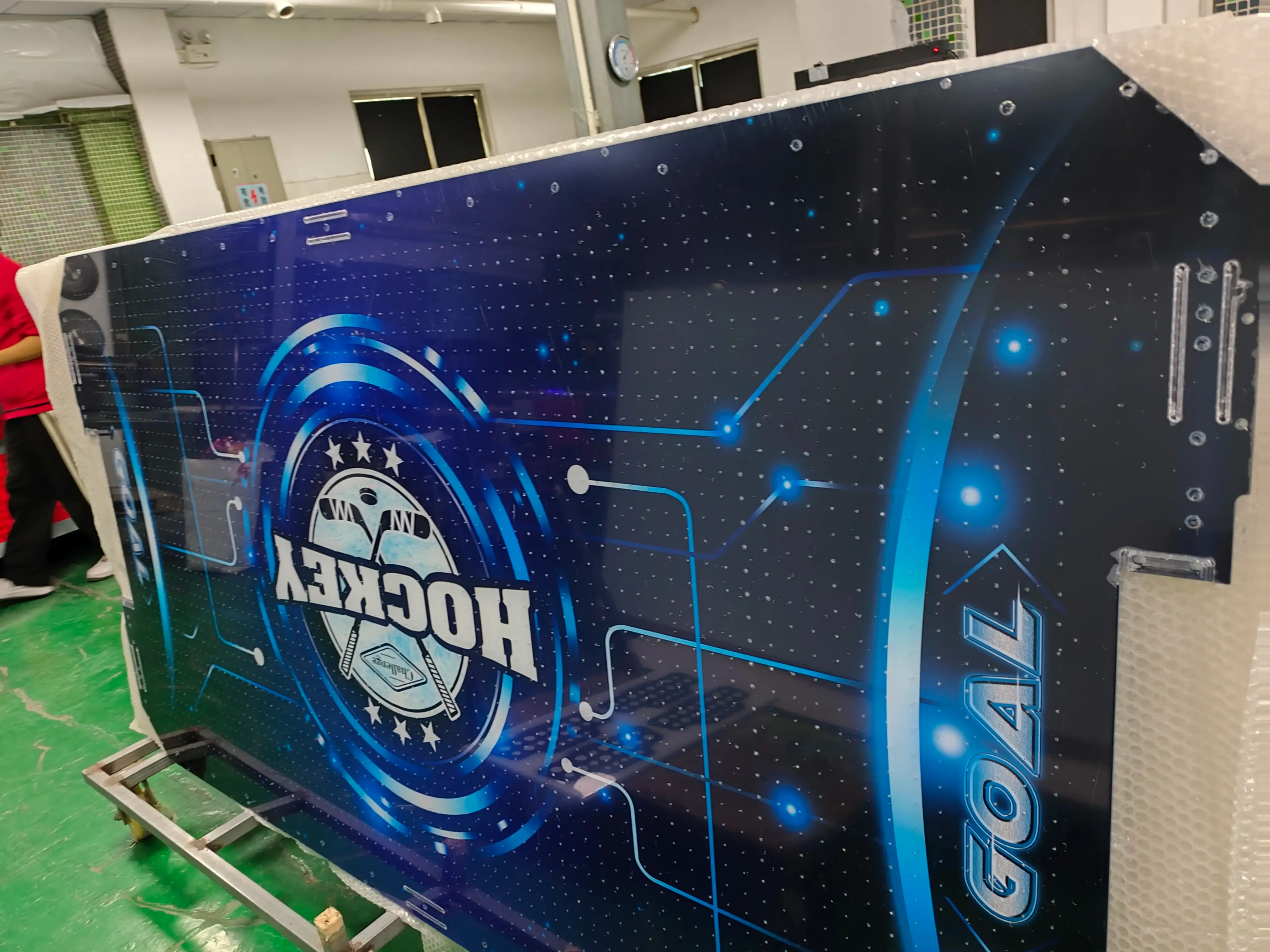 Hockey-themed game machine exterior panel made via UV flatbed direct printing on acrylic—features space tech-style design with