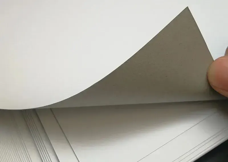 Baosiwei digital carton printer compatible material sample: white paper on gray background.