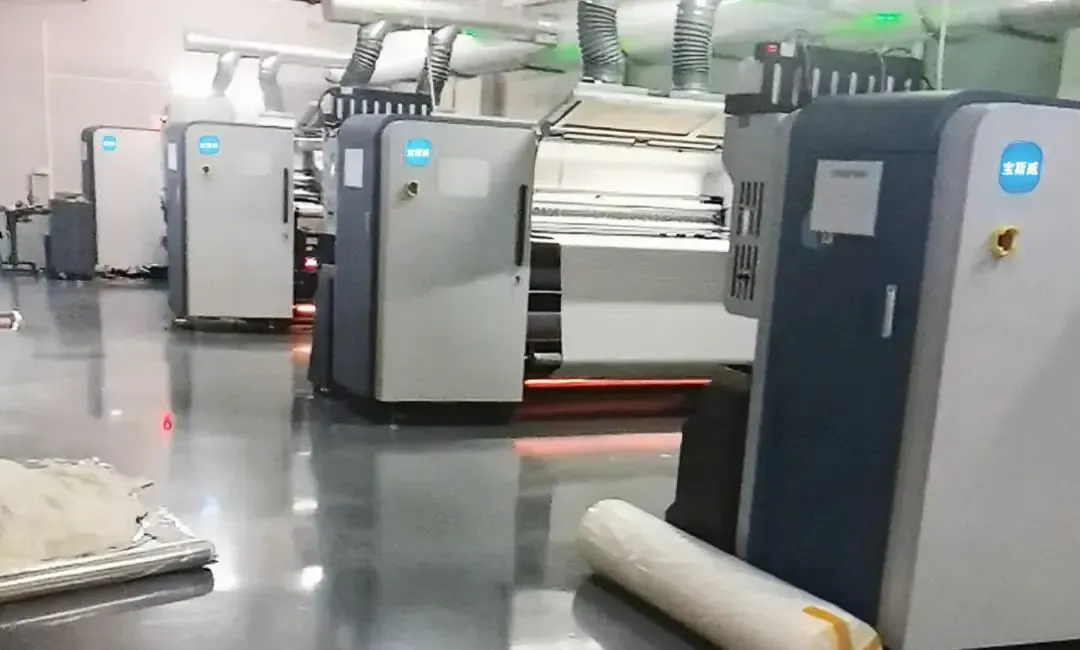 Customer factory using the Baosiwei PET film transfer printing solution for full production, with Baosiwei digital printers operating on-site