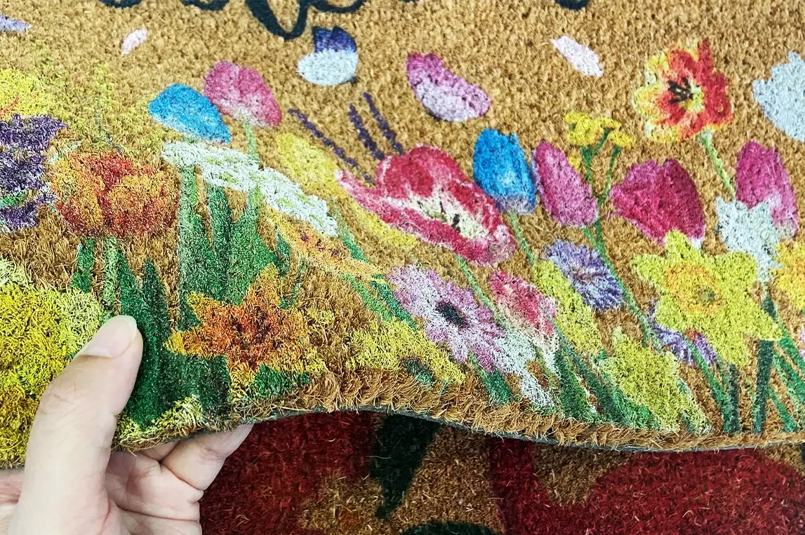Coir mat with vibrant flower design, printed by Baosiwei UV flatbed printer, where the ink penetrates deep into the coir fibers for long-lasting durability.