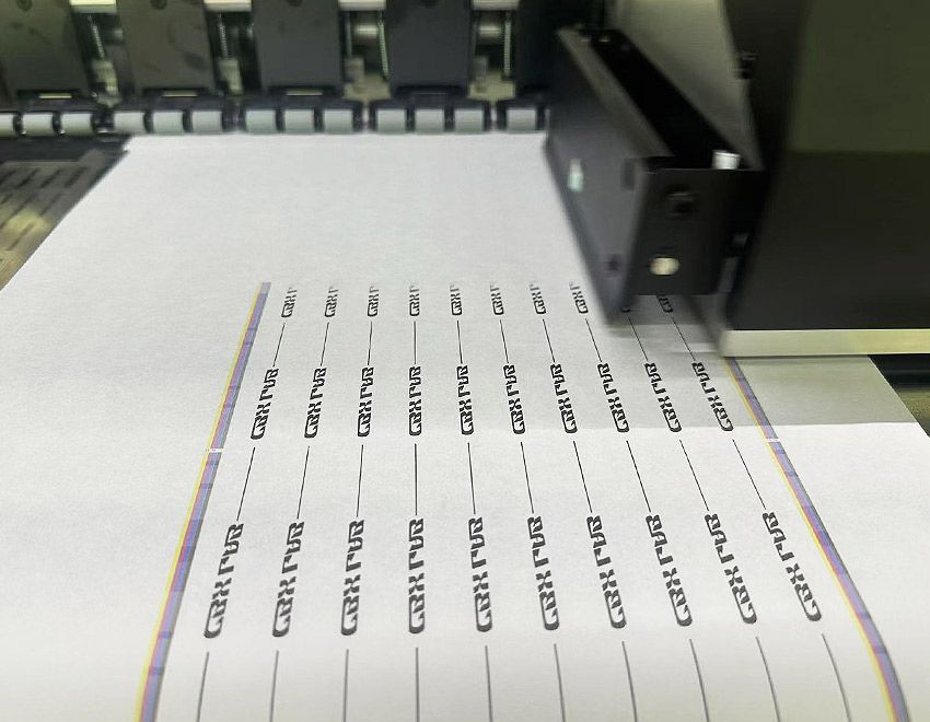 This is a photo of a printhead printing small text, showing the font as bold, clear, and complete.