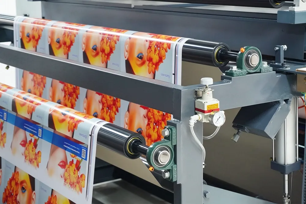 Baosiwei auto web guiding system — multi-row printed packaging rolls with baby pattern aligned on conveyor ensuring precise registration before cutting