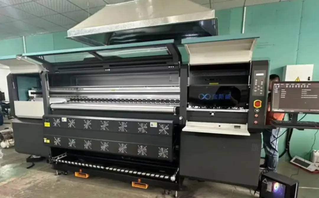Baosiwei 16-head textile printer in a factory workshop, applied in the heat transfer printing solution for floor mats; a worker operates the device beside the control screen.