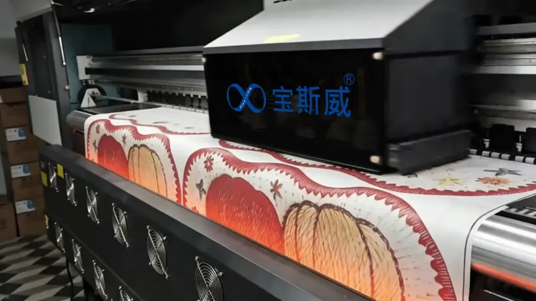 Baosiwei 16-head textile printer in a factory workshop, using sublimation ink to print pumpkin-patterned designs onto transfer paper.