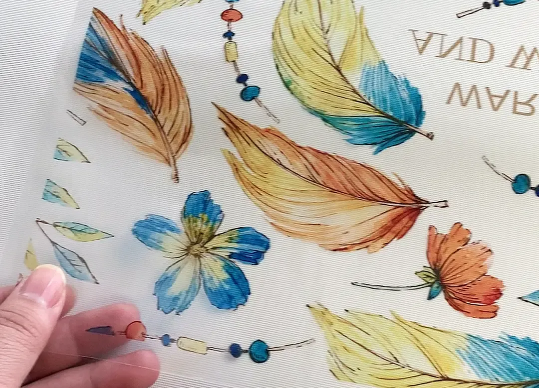 Baosiwei PET film digital printer printed sample showing clear feather and flower patterns on PET film