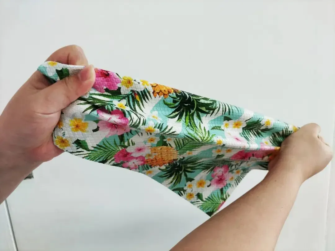 Baosiwei durability test on another PET film printed tablecloth pattern showing no cracking after stretching