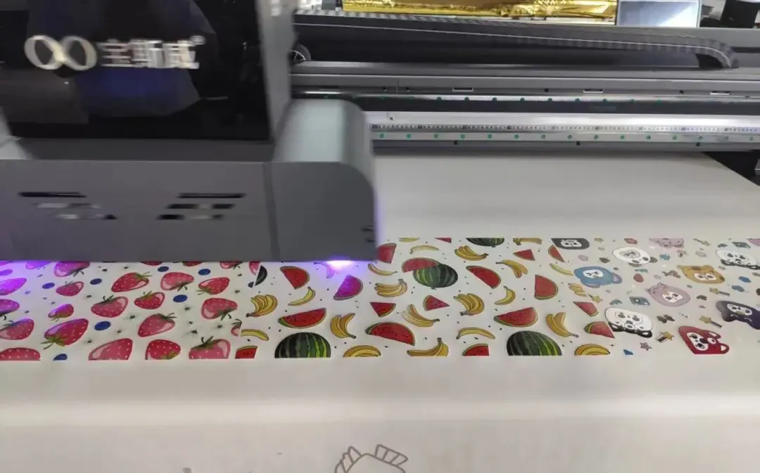Baosiwei UV hybrid printer in operation, printing a floor mat roll (featuring strawberry, banana, watermelon and cartoon patterns) — demonstrating the device’s roll-to-roll mat printing capability.