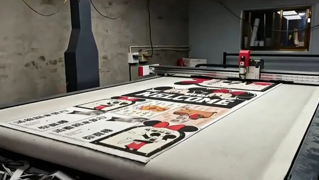 CNC cutting machine in a workshop, processing floor mat material printed with Mickey Mouse patterns and